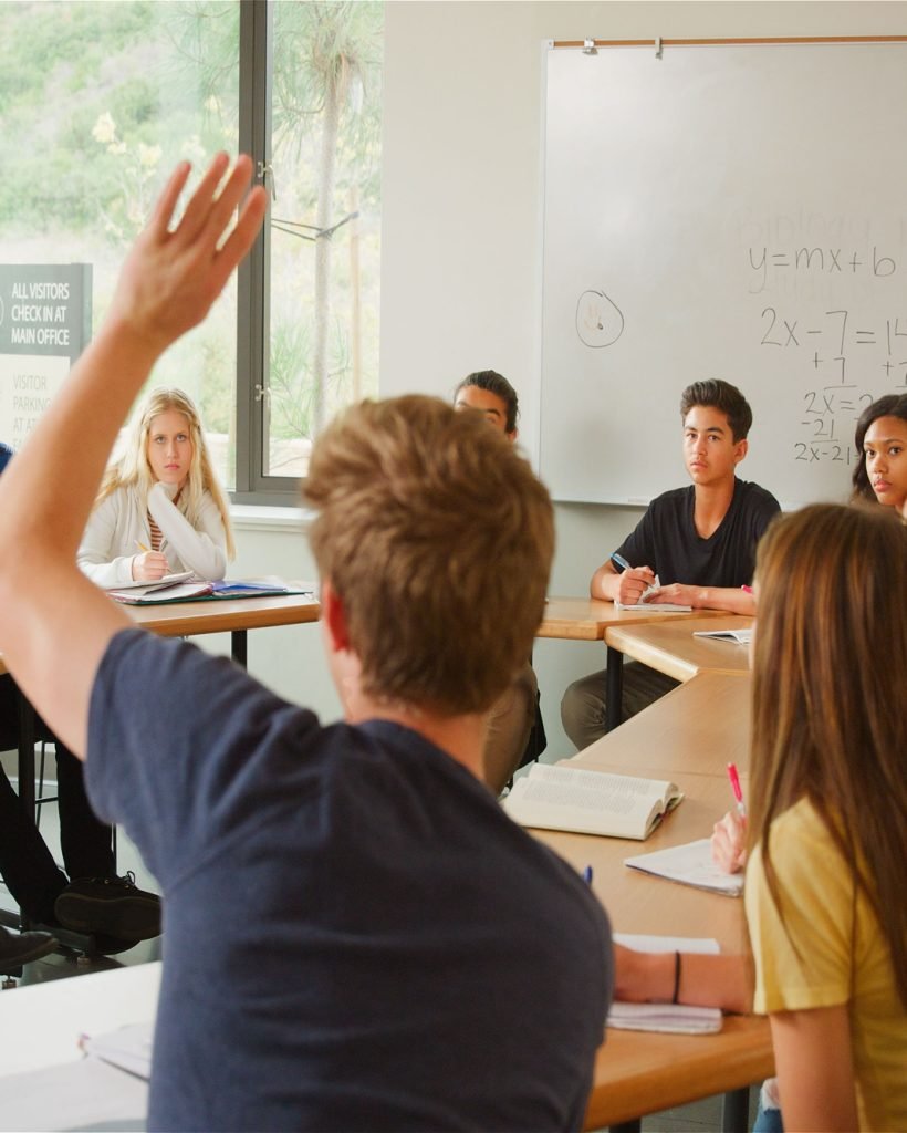 Male Student Asking Tutor Question Tutor In High School College Or University Students Maths Class