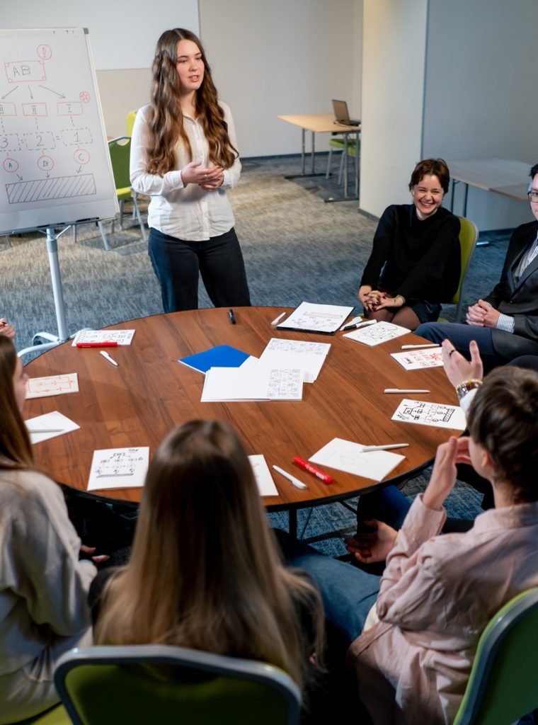 business conference or meeting at the hotel the girl on the flipchart shows the development plan for company